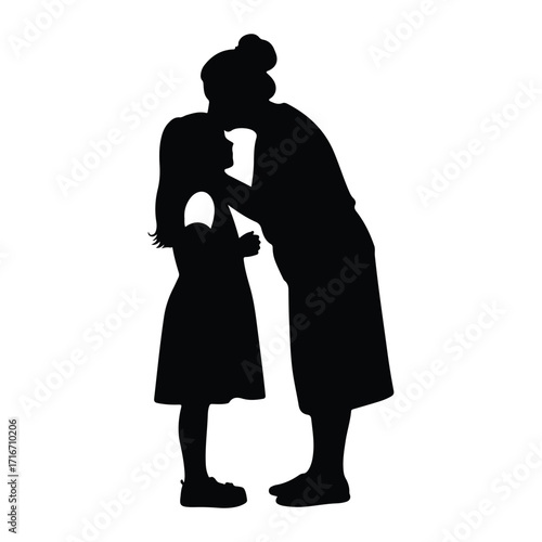 Mother kissing daughter silhouette embrace
