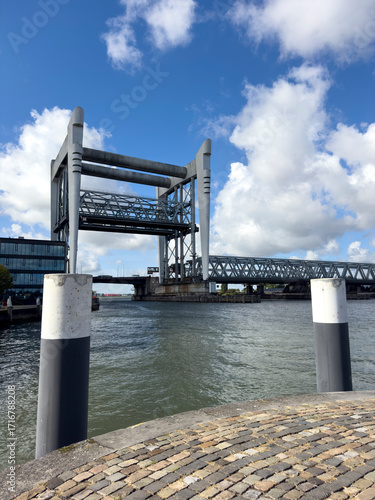 Dordrecht Railway Bridge spans the Oude Maas, raised to allow tall ships to pass, showcasing Dutch engineering and river traffic.