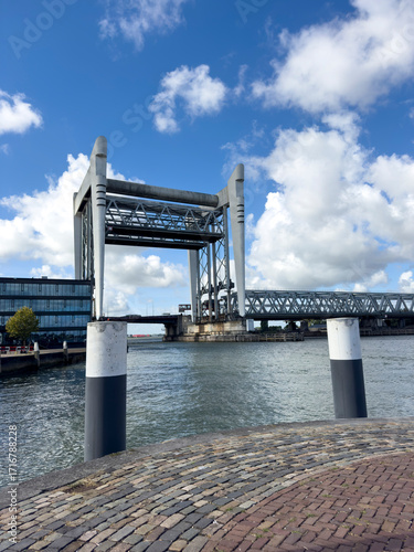 Dordrecht Railway Bridge spans the Oude Maas, raised to allow tall ships to pass, showcasing Dutch engineering and river traffic.