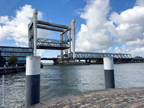 Dordrecht Railway Bridge spans the Oude Maas, raised to allow tall ships to pass, showcasing Dutch engineering and river traffic.