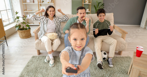 Cute little girl with TV re...