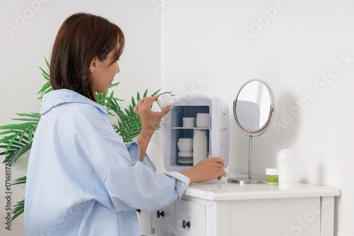 Young woman with small refr...