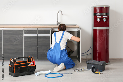 Female plumber sink in kitc...
