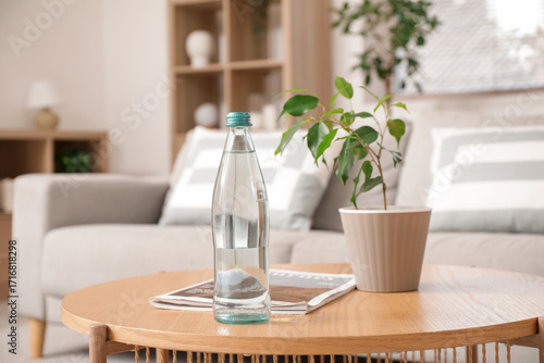 Bottle of water with magazi...