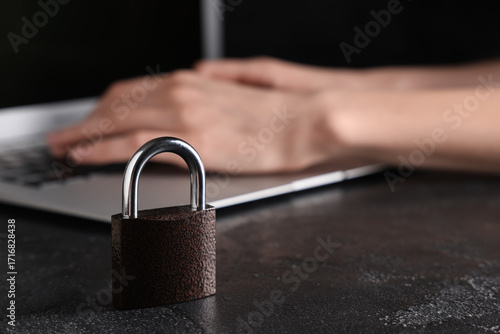 Padlock on dark table, clos...