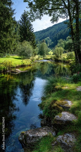 Scenic river flowing through a lush green valley. Reflecting trees and mountains. Clear water
