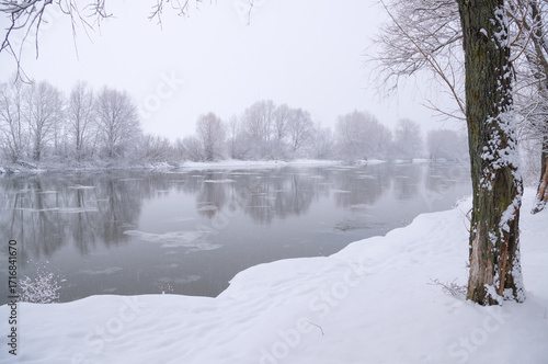 Landscape of a frozen river on a cloudy winter day.