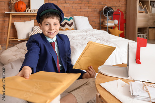 Teenage postman with envelo...