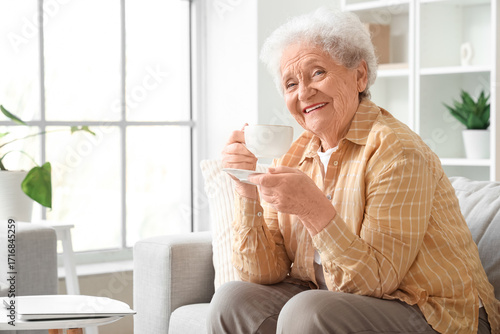 Senior woman with cup of bu...