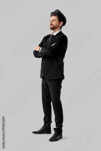 Handsome chauffeur on grey ...
