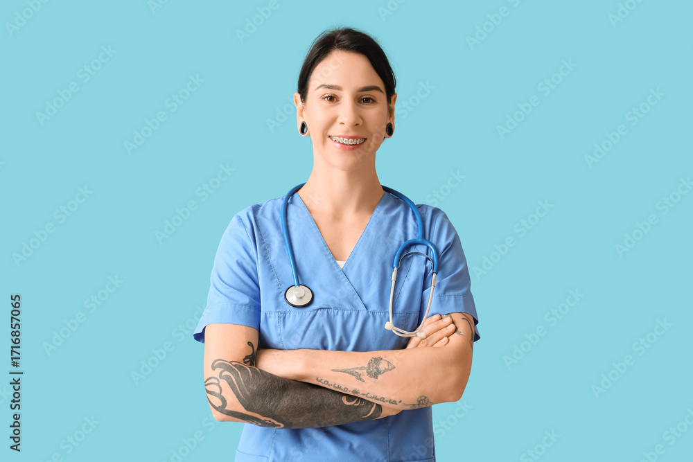© Pixel-Shot - Tattooed female doctor on blue background