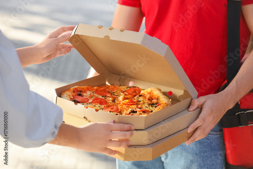 Male courier delivering piz...