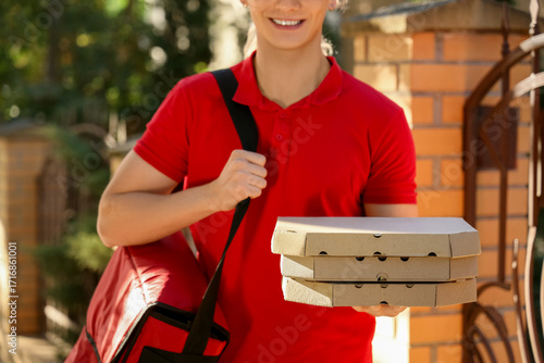 Male courier with pizza box...