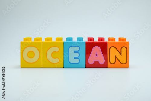 Fotografi Colorful toy blocks spelling OCEAN on a clean white background