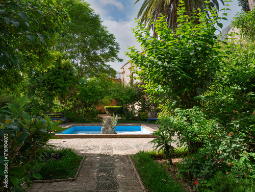 Kasbah garden with fountain and greenery in Chefchaouen, Morocco