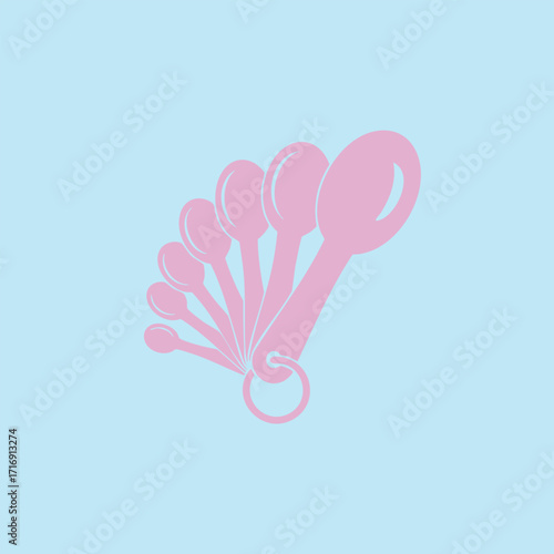 Set of pink measuring spoons fanned out on a light blue background for precise cooking and baking measurements