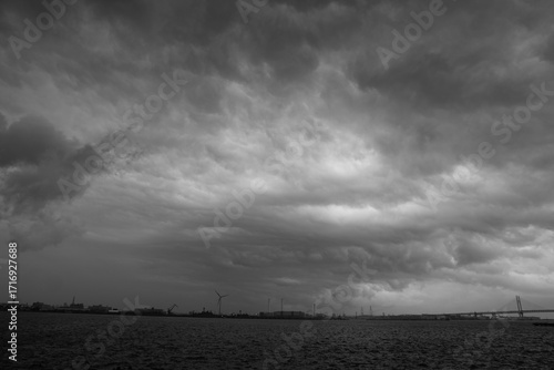 Dramatic Black and White Sky with Storm Clouds over a Rural Landscape