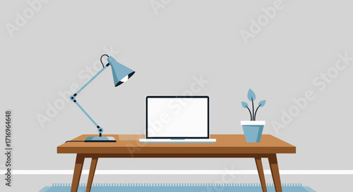 Simple home office workspace with laptop, lamp, and plant on a wooden table.