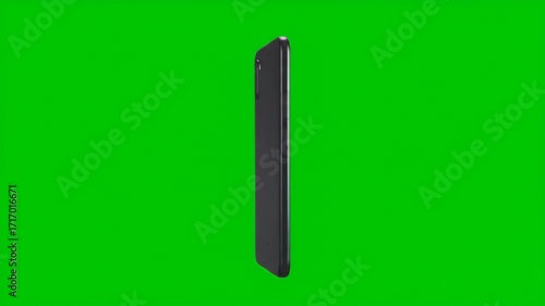 Isolated black smartphone standing vertically against green background.
