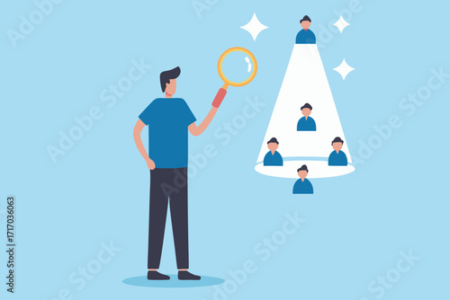 Man with magnifying glass searches for the best candidate among a group of people