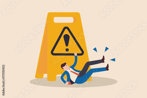 Business man slipping and falling on a wet floor caution sign in an office environment