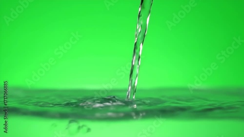 A gentle pour of water creating a soft, rippling splash as it hits a surface, isolated on green screen fluid, footage, gentle pour of water