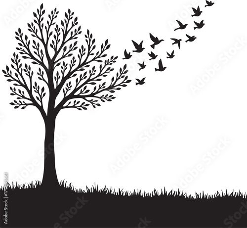 Black silhouette tree with flock of birds flying away