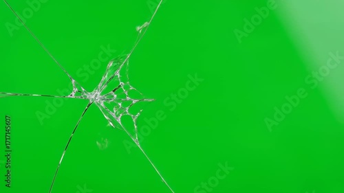 A perfectly smooth glass surface cleanly cracking across its entire width, isolated on a vibrant green screen festive, chrome key, fragments