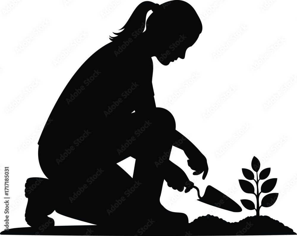 Fototapeta premium Silhouette of a woman planting a seedling