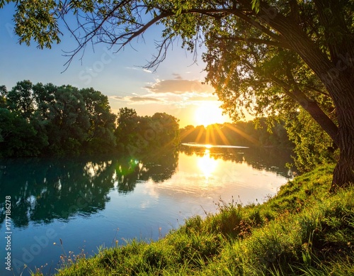 Tableau sur toile GenA breathtaking view of a golden sunset over a calm river surrounded by lush green trees