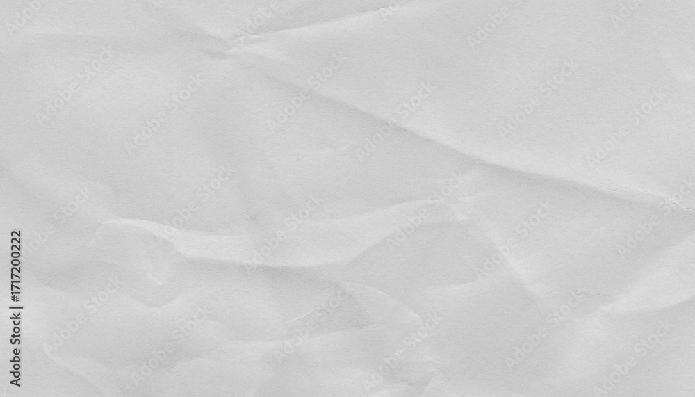 Obraz premium Crumpled white paper texture with subtle folds and creases, ideal for backgrounds or design elements. surface is matte and slightly uneven, adding tactile quality