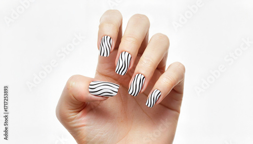 Elegant woman's hand displaying zebra-striped nail art on white background  