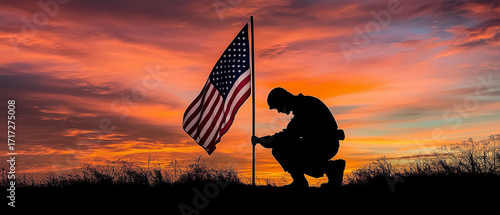 Kneeling Respect: A poignant and emotional silhouette of a soldier kneeling on one knee, head bowed slightly, holding the staff of the American flag planted firmly in the ground