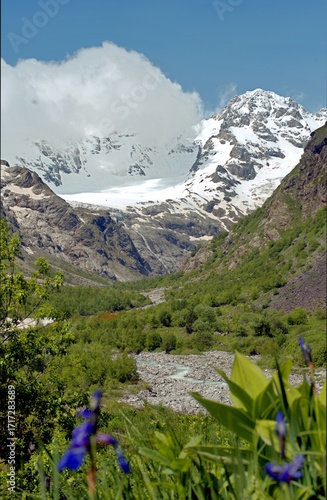 Mountain landscape with a view of a glacier. Tana Glacier in North Ossetia. Melting glaciers in the highlands.