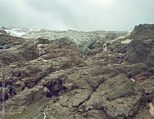 Mountain landscape with a view of a glacier. Tana Glacier in North Ossetia. Melting glaciers in the highlands.