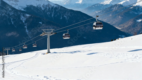 Snow-covered mountain landscape with a cable car system transporting passengers across a ski slope