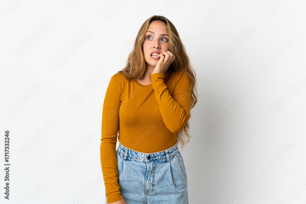 Fototapeta Young blonde woman isolated on blue background is a little bit nervous