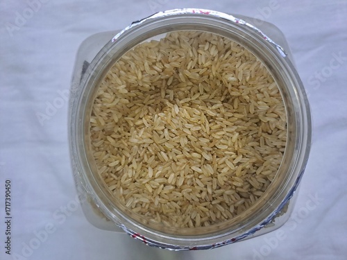 Brown rice in a plastic jar 