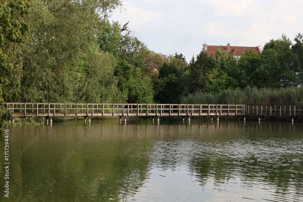 Obraz premium Wooden bridge over a lake. Raark Bünde. Germany.