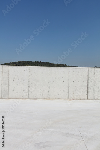 Minimalist Concrete Wall with Clear Blue Sky