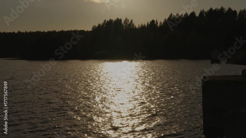 A Tranquil and Serene Sunset Over the Calm Water Reflection in the Embrace of Nature