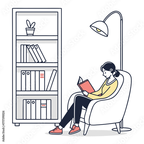 A young woman comfortably sits in a plush armchair reading a book under a floor lamp next to a bookshelf