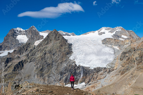 girl admiring the view of the glaciers with waterfall and rainbow