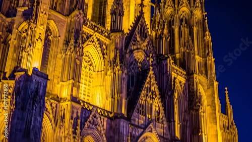 Gothic cathedral facade lit golden at night