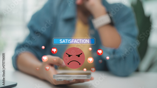 Unhappy customer giving negative feedback on smartphone. Concept of dissatisfaction, poor service experience, bad review, low rating, complaint, and business reputation damage.