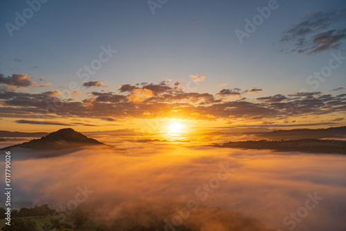 The most beautiful warm sunrise above auvergne montain with orange fog valey