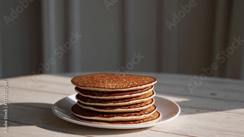 Wallpaper Mural A Stack Of Pancakes On A White Plate Sits On A Sunlit Wooden Table Indoors, Creating A Warm And Inviting Breakfast Scene Torontodigital.ca