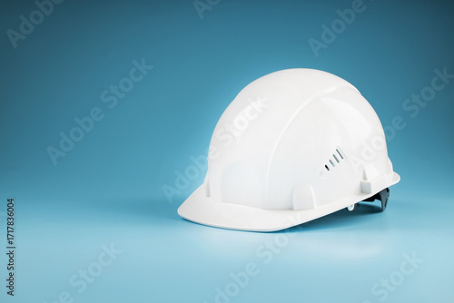 Construction worker's safety helmet white on blue background