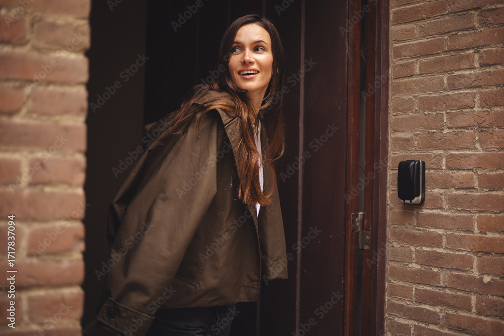 Slika na platnu Pretty brunette long hair woman in casual outfit going out of house