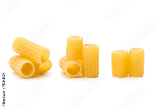 Εκτύπωση καμβά Three groups of uncooked rigatoni pasta tubes on a white background